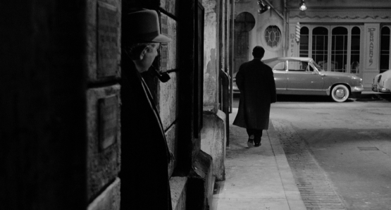 Jean Gabin, as Inspector Jules Maigret, shadows a suspect in MAIGRET AND THE ST. FIACRE CASE.