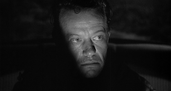 William Talman's Emmett Myers emerges from the shadows in Ida Lupino's THE HITCH-HIKER.