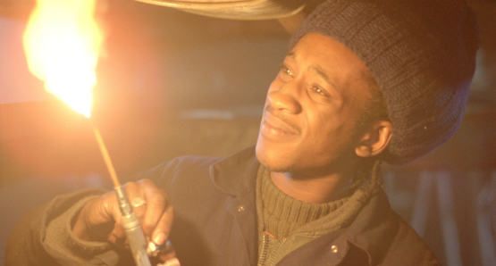 By day, Blue (Brinsley Forde) works as a mechanic in Franco Rosso's BABYLON.