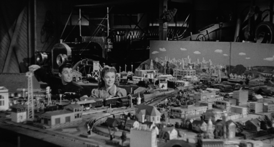 Drew (Keefe Brasselle) shows off his train set to Sally (Sally Forrest) in Ida Lupino's NOT WANTED.
